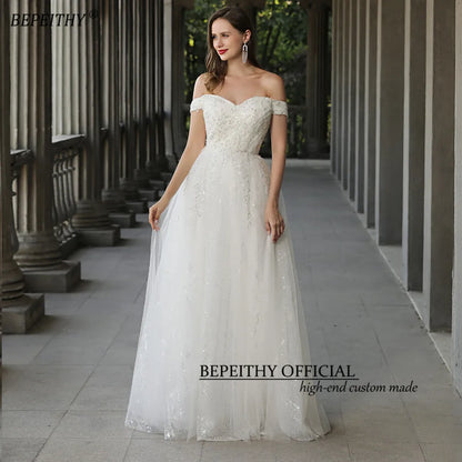 BEPEITHY Glittler Lace Vestidos de novia marfil para mujer 2023 Sin mangas Fuera del hombro Lujoso vestido de novia largo hasta el suelo