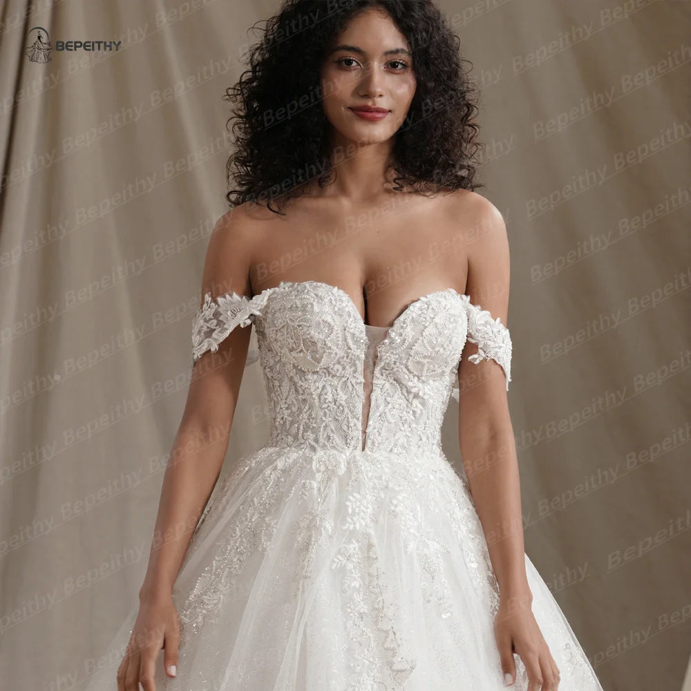 BEPEITHY Vestidos de novia de princesa con escote en forma de corazón y purpurina para mujer 2024 Vestido de novia sin mangas con cola de corte y hombros descubiertos en color marfil